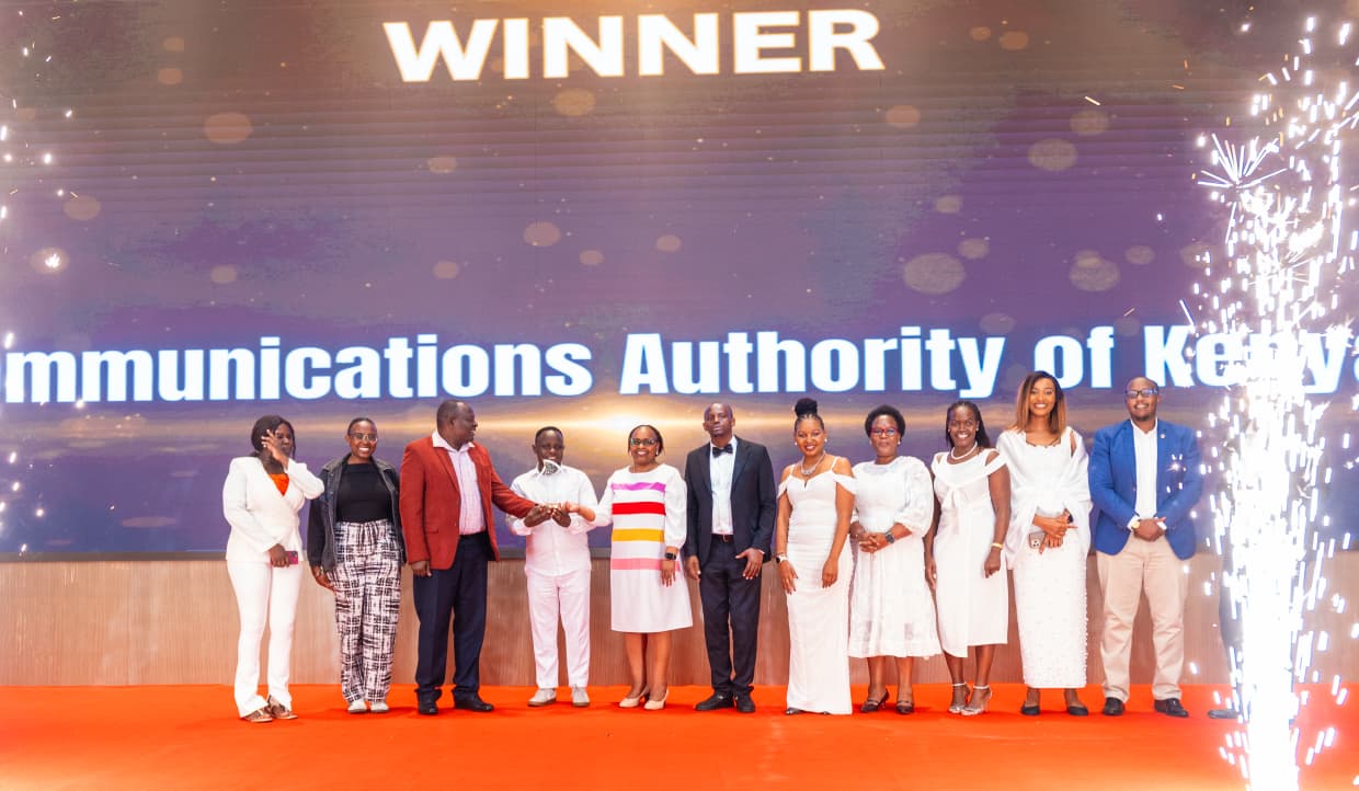 CA team leader by CS Lydia Sitienei pose for a group photo after being presented with a trophy 